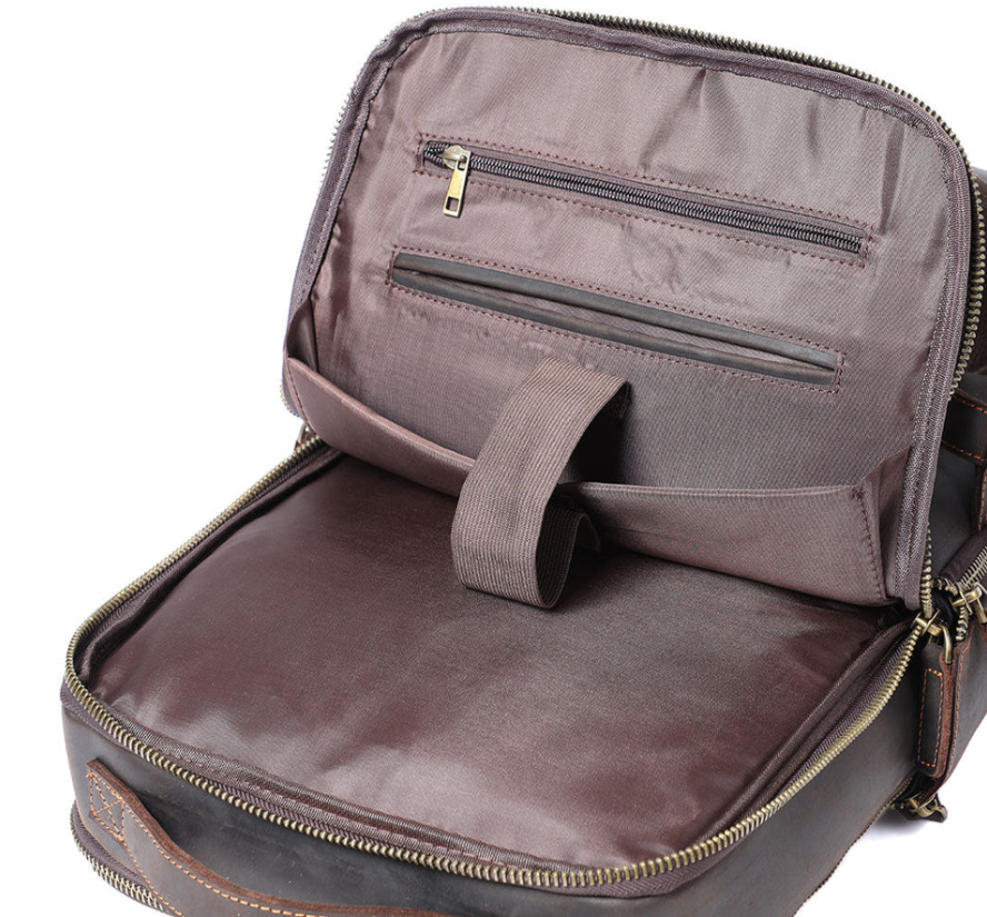 Interior view of the Loch Ness leather laptop rucksack showing spacious compartments and zipper pockets.