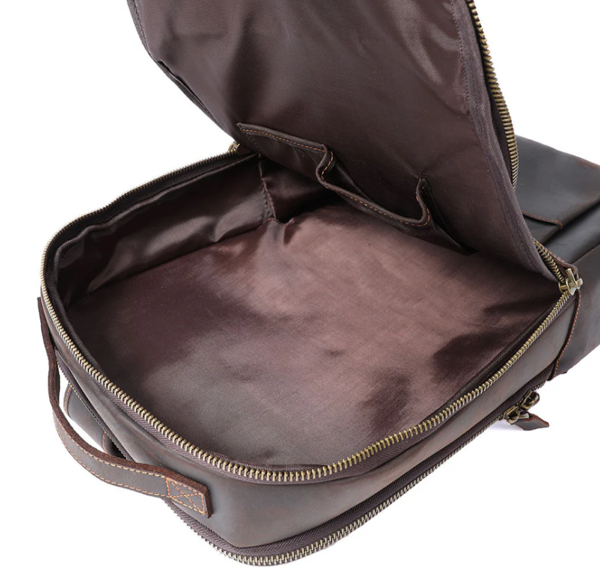 Interior view of the Loch Ness leather laptop rucksack showing spacious, lined compartments.