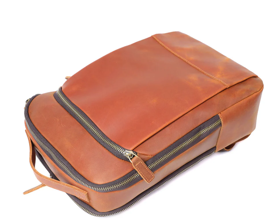 Top view of a stylish Leather Laptop Rucksack in warm brown, showcasing premium leather and zippered compartments.