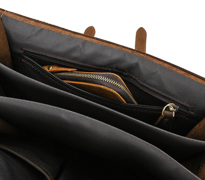 Interior view of a leather rucksack featuring a zippered pocket and spacious compartments for organization.