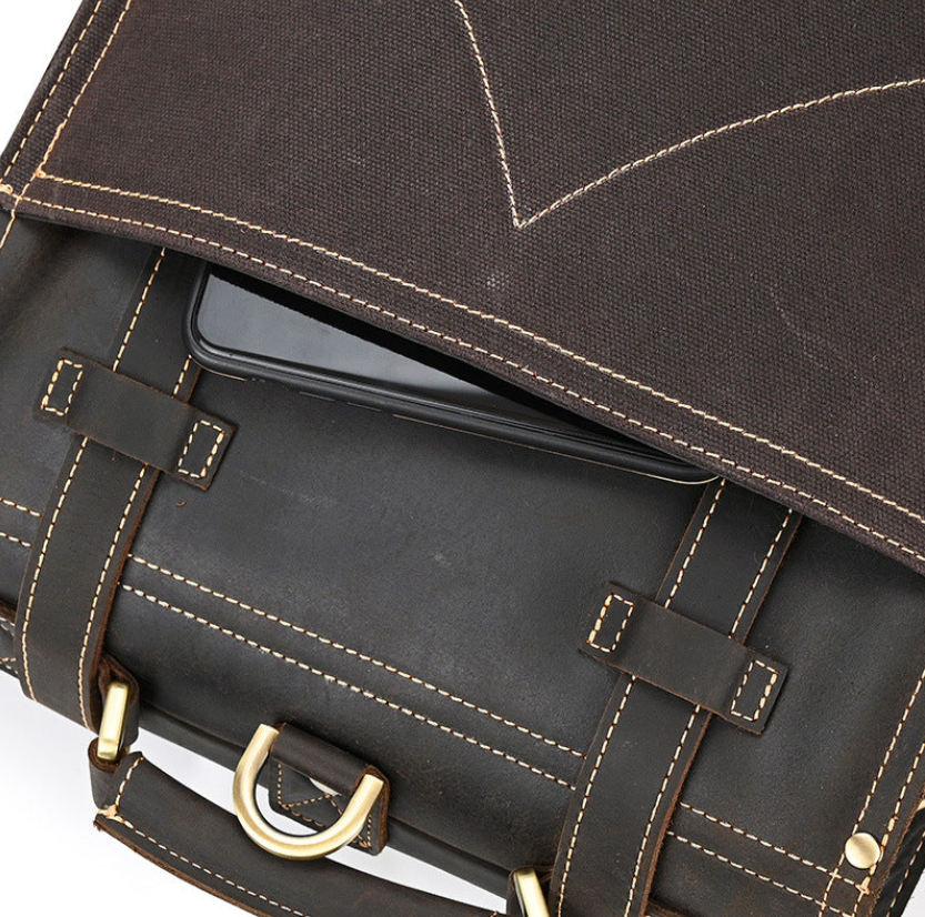 Close-up of the Leather Rucksack from Smokies, showcasing the top flap with a device inside.