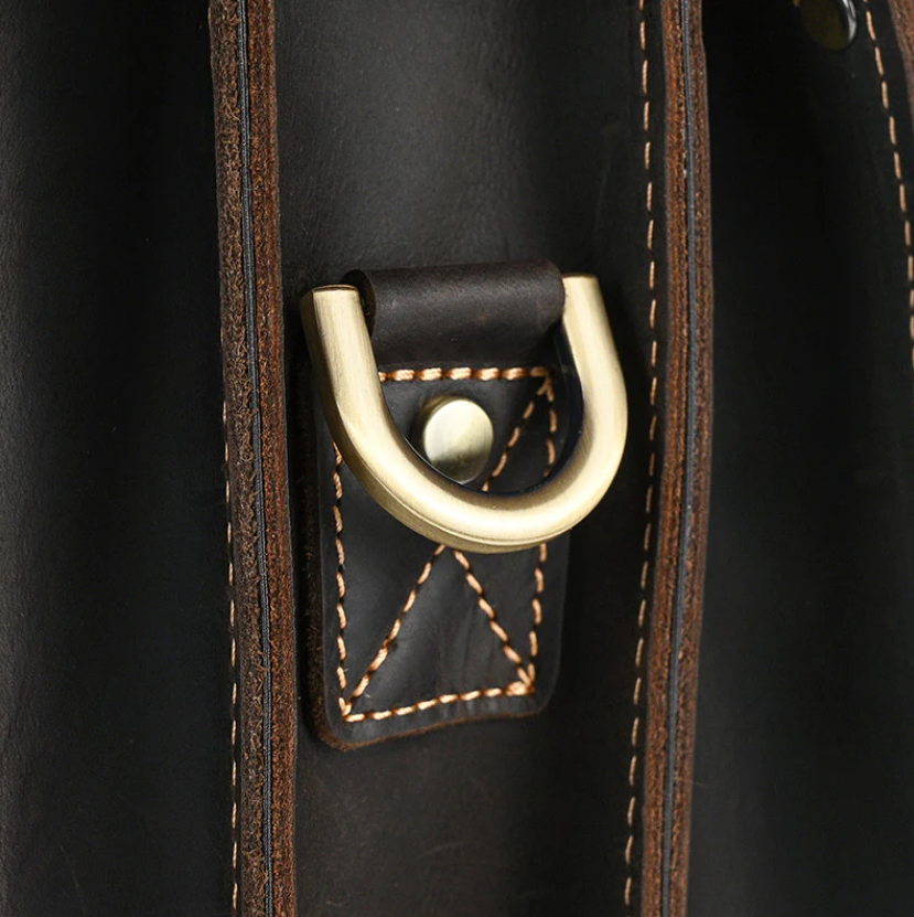 Close-up of brass hardware and stitching detail on Smokies leather rucksack, showcasing craftsmanship.