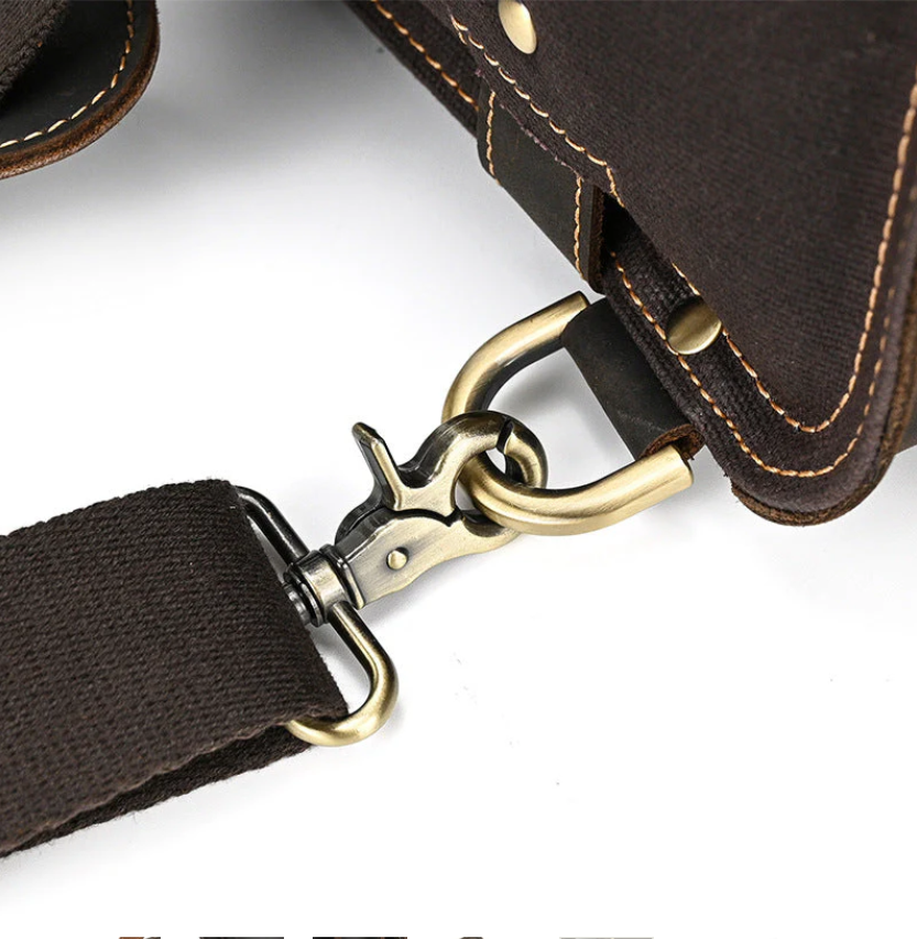Close-up of the clasp mechanism on a durable leather rucksack strap, showcasing quality craftsmanship.