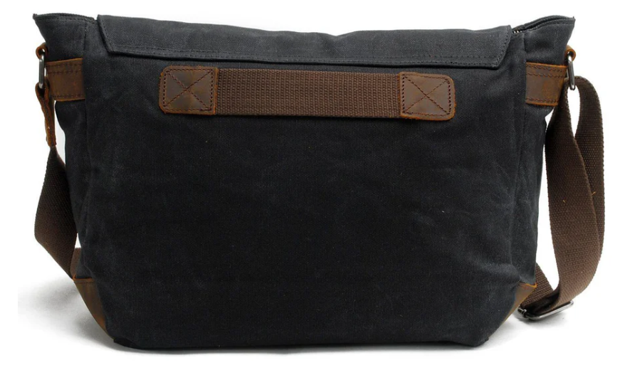 Retro shoulder bag in black canvas with brown straps, perfect for stylish everyday use.