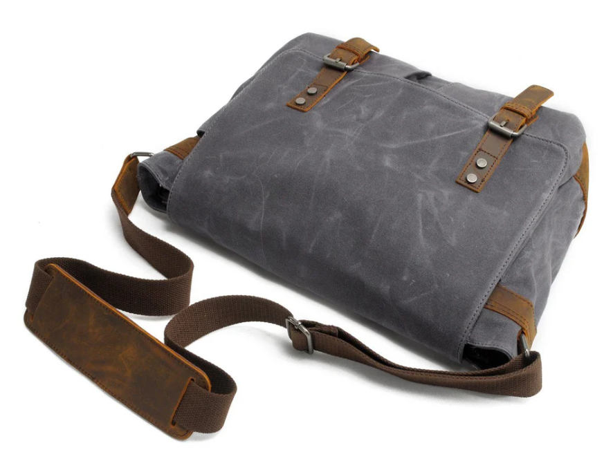 Retro shoulder bag in grey canvas with brown leather accents and adjustable strap, perfect for stylish everyday use.