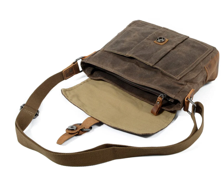 Small canvas messenger bag by Pyrenees, featuring a sturdy strap and spacious interior for essentials.