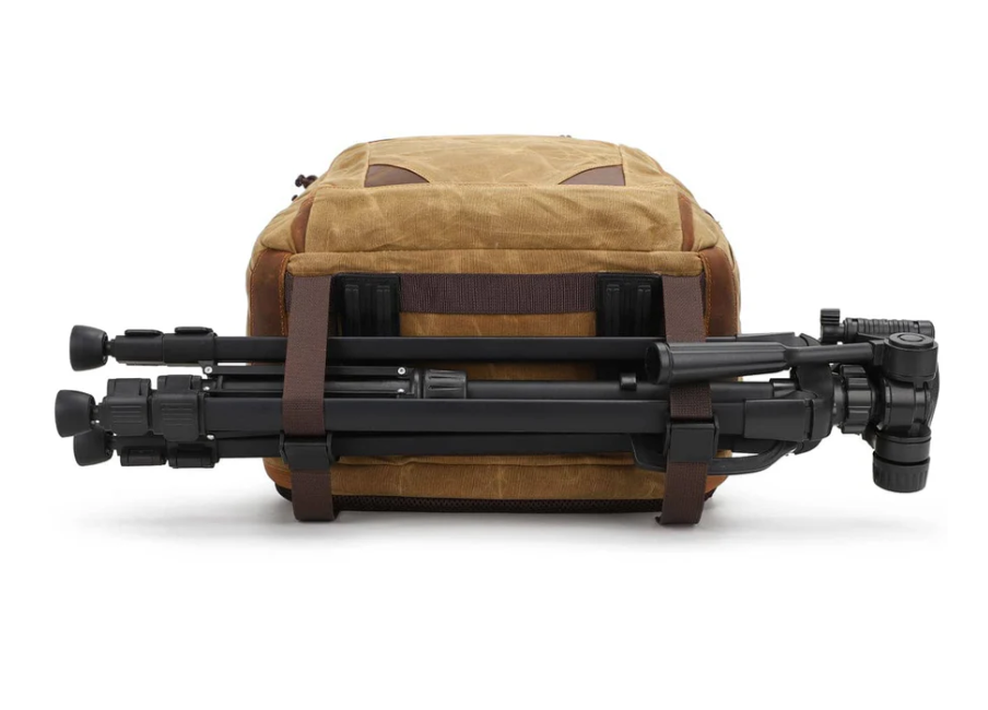 Vintage camera backpack from Sierra Nevada with a tripod securely attached, showcasing its rugged design.