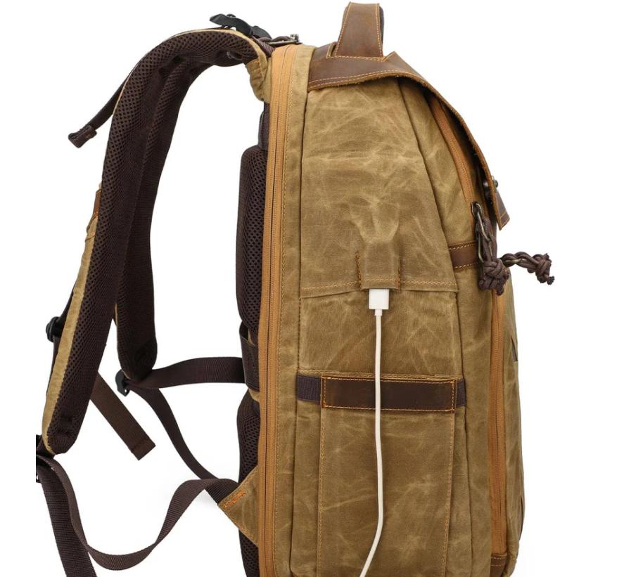 Side view of the vintage Sierra Nevada camera backpack with charging port and rugged design.