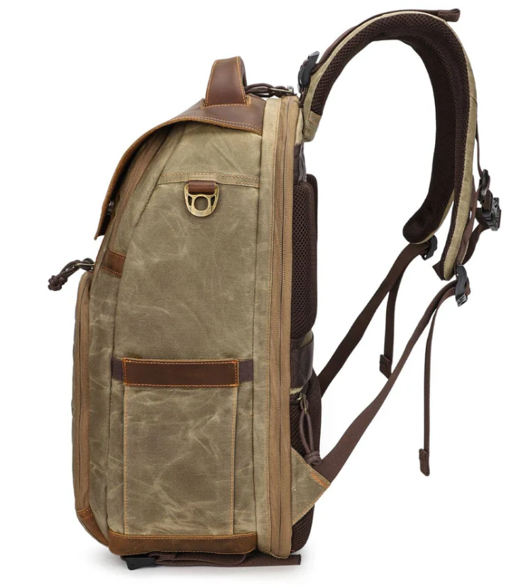 Vintage camera backpack in olive green with brown leather accents, perfect for photographers on the go.
