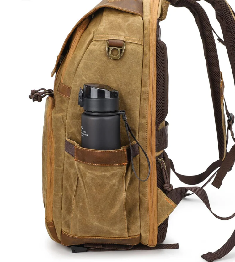 Vintage camera backpack features side pocket with water bottle, ideal for outdoor photography adventures.
