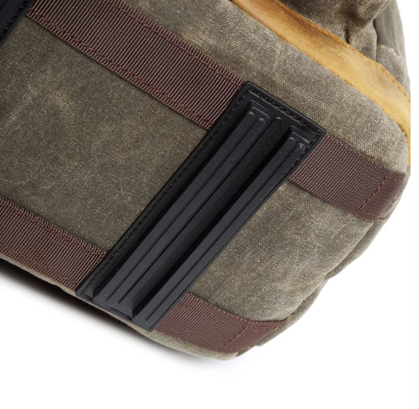 Close-up of the waterproof canvas camera backpack showcasing durable straps and rugged texture.