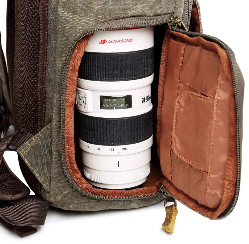 Close-up of waterproof canvas camera backpack showing its interior compartment designed for lens storage.