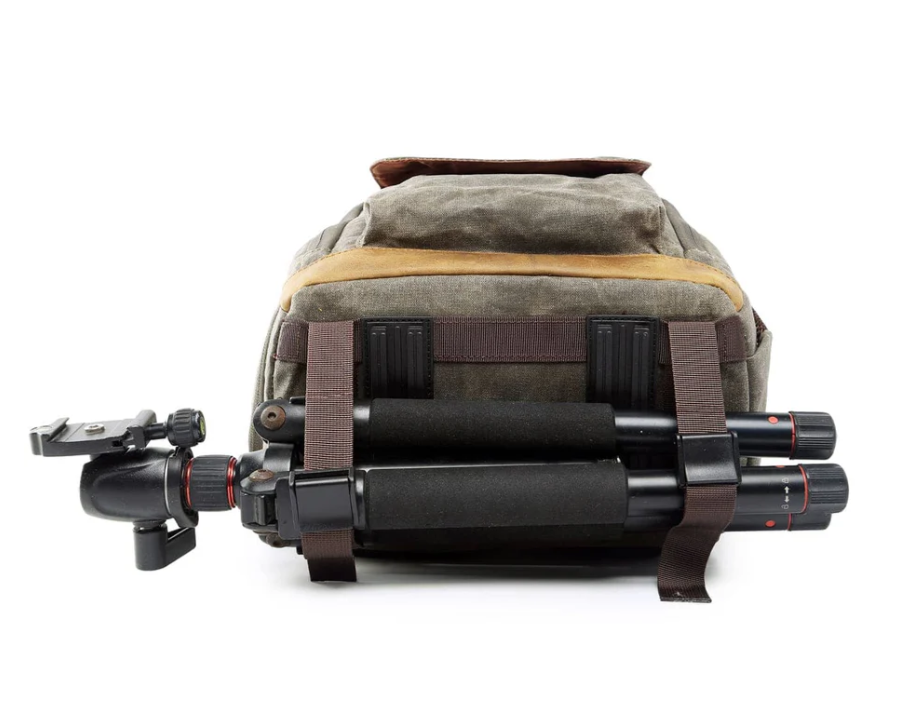 Waterproof canvas camera backpack with tripod attached, designed for adventure photography in harsh conditions.