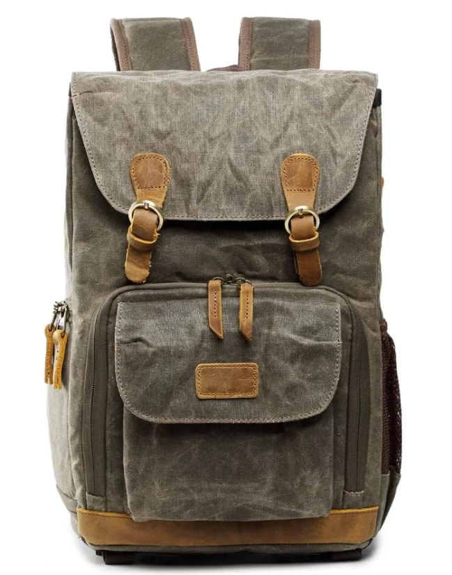 Waterproof canvas camera backpack in gray with brown leather accents, designed for outdoor photography adventures.