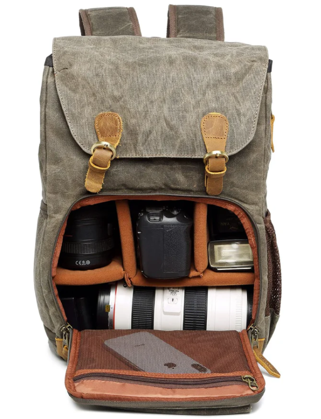 Waterproof canvas camera backpack open, showcasing padded compartments for lenses and DSLR, ideal for photographers.