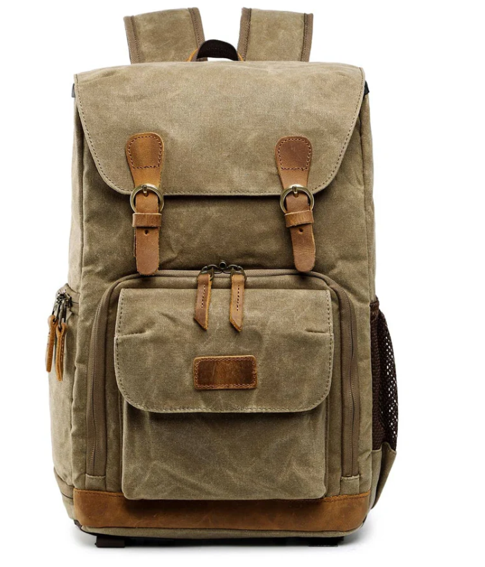Waterproof canvas camera backpack in beige with leather accents, perfect for photographers on outdoor adventures.