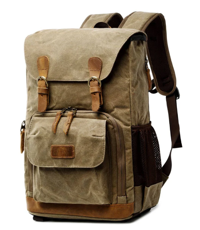 Stylish waterproof canvas camera backpack with multiple pockets and adjustable straps, perfect for adventurers.