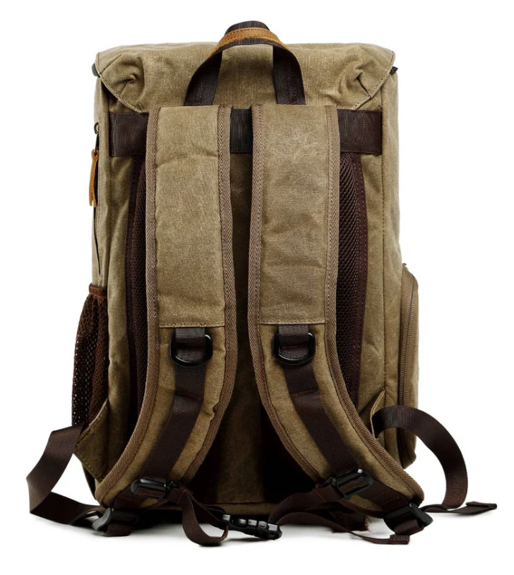 Waterproof canvas camera backpack in brown with padded shoulder straps and side mesh pockets, ideal for outdoor photography.