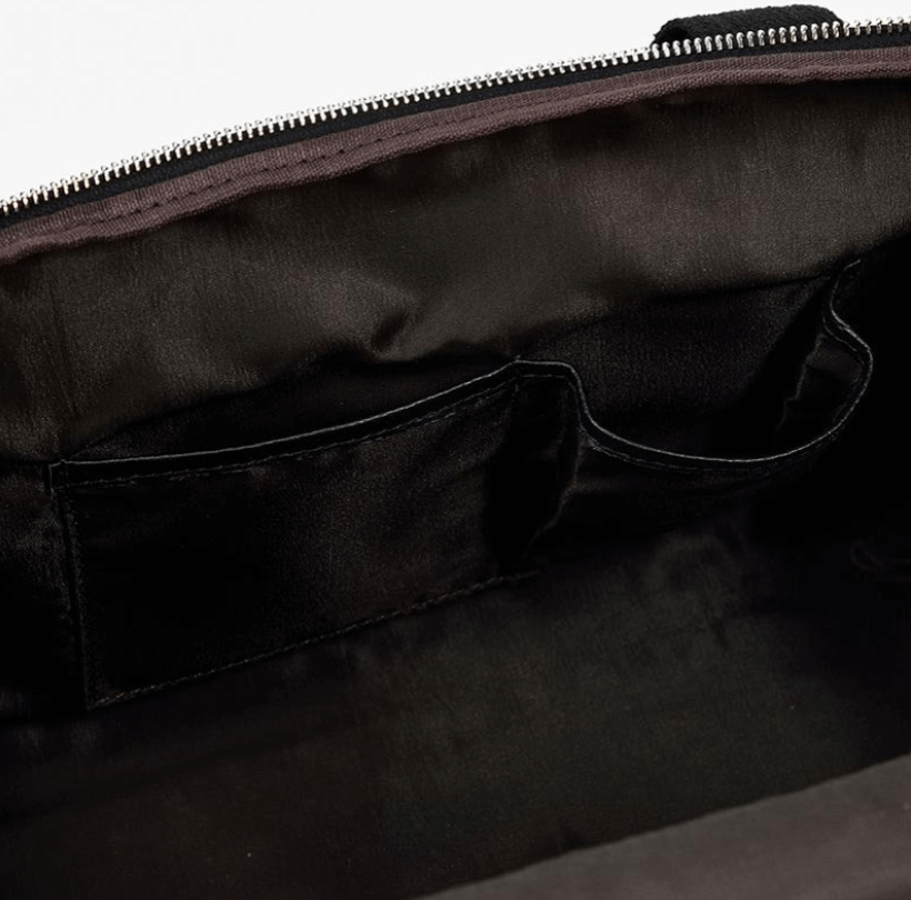 Interior view of a black leather duffle bag showing spacious compartments and sleek design.