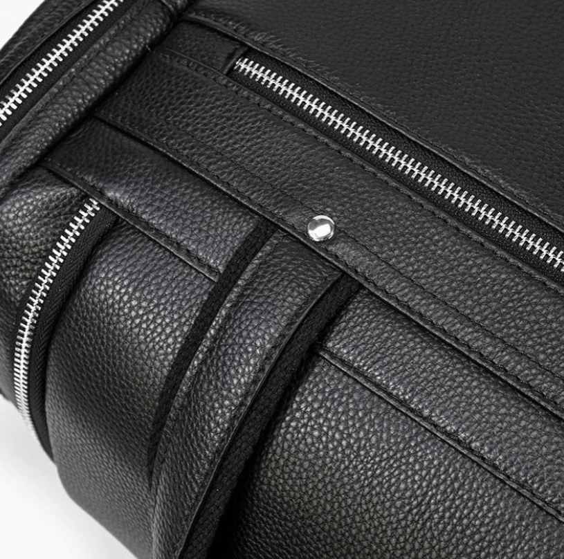 Close-up of a black leather duffle bag from Norwegian Fjords, highlighting its zipper and textured surface.