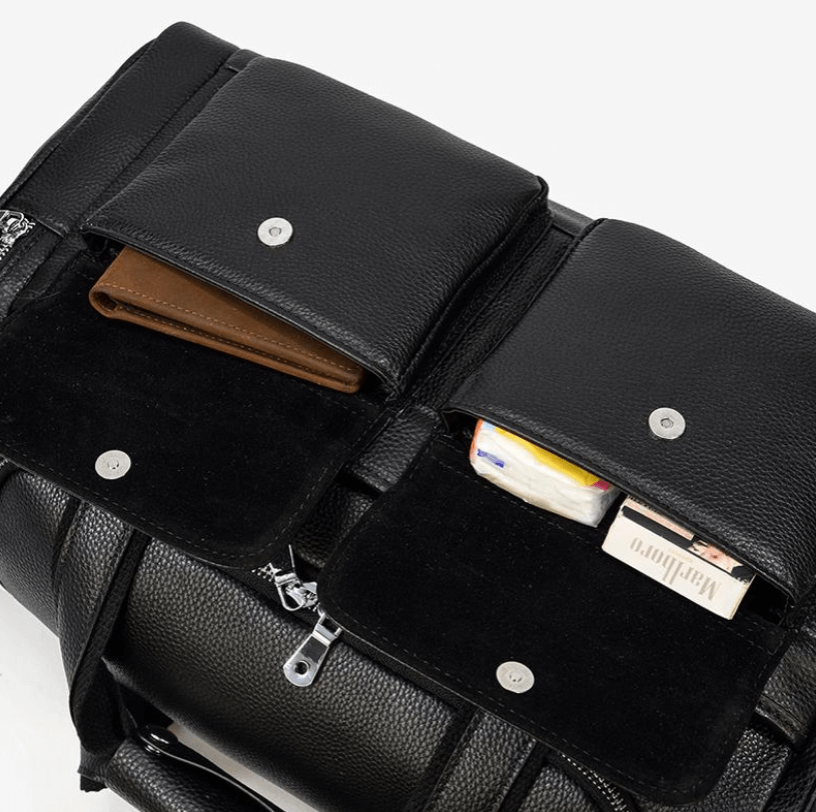 Interior view of a black leather duffle bag showing two pockets with items, designed for style and organization.