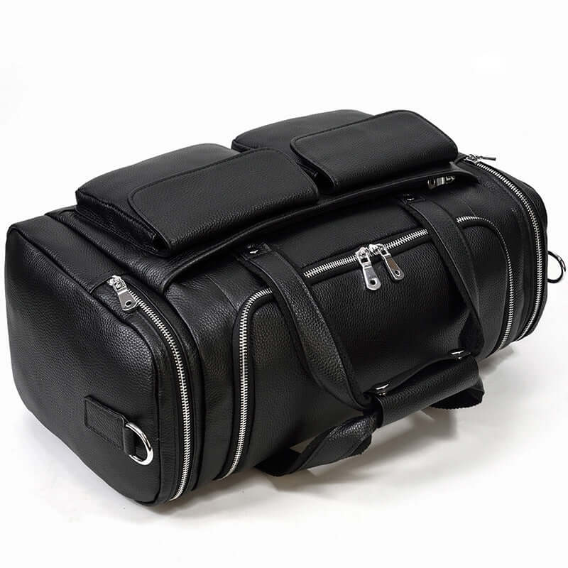 Black leather duffle bag featuring multiple pockets and sturdy zippers, perfect for travel and outdoor adventures.
