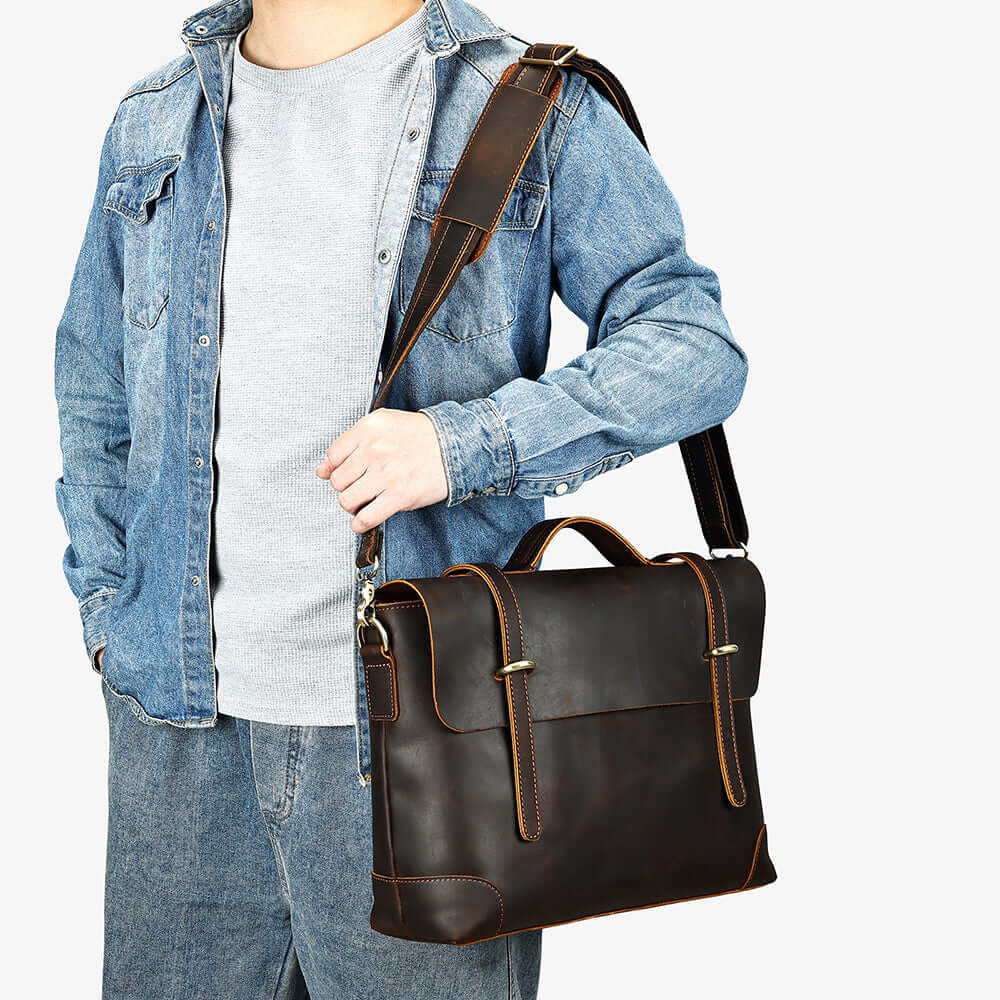 Brown leather handbag showcased on a man with a denim jacket, highlighting its stylish and versatile design.