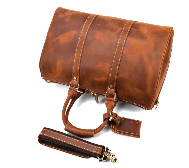 Premium leather duffle bag in rich brown color, featuring sturdy straps and a detachable shoulder strap for versatility.