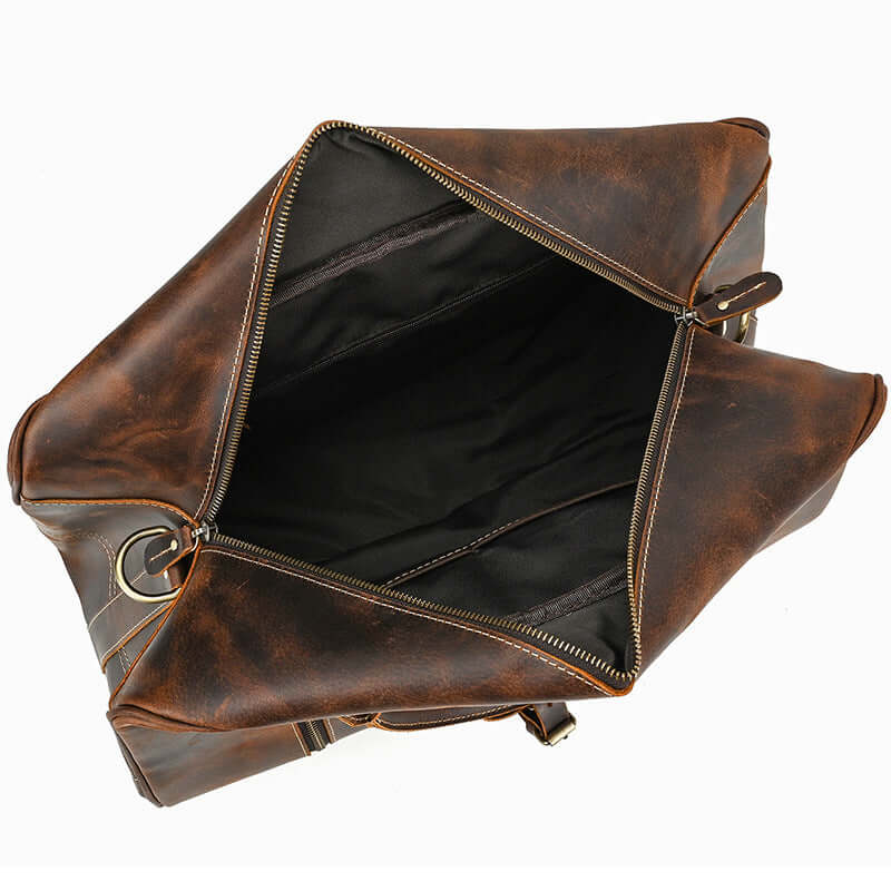 Interior view of the leather overnight bag, showcasing spacious compartments and rich brown texture.