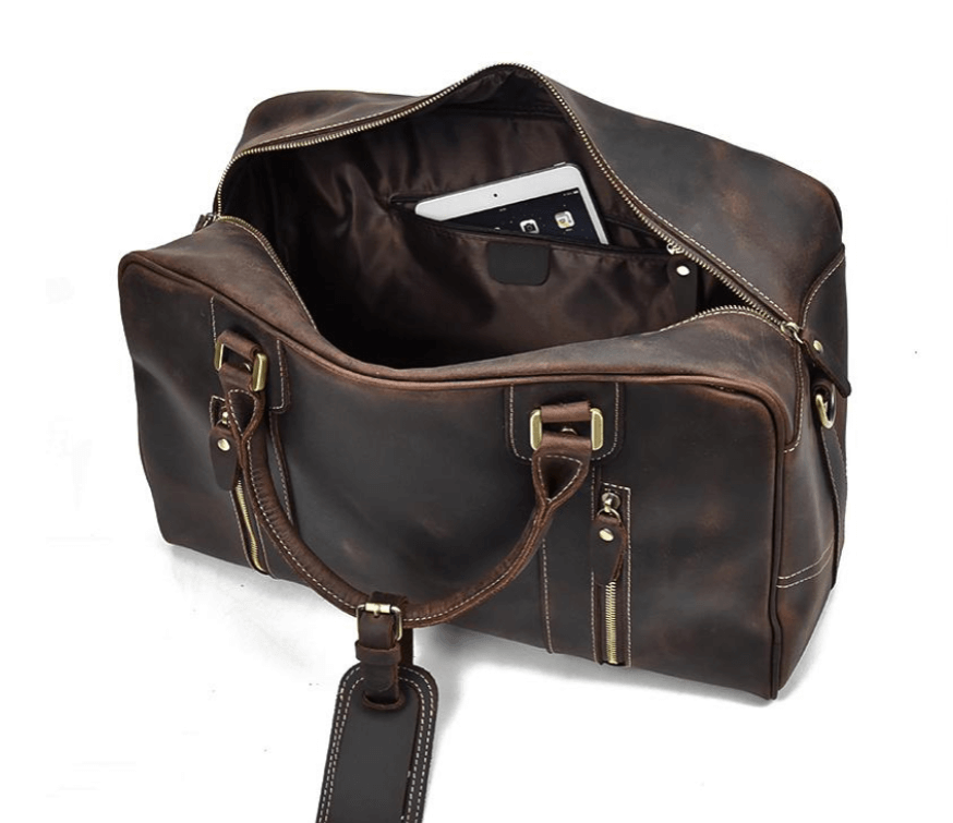 Spacious leather overnight bag featuring a zippered closure, sturdy handles, and interior pocket for organization.